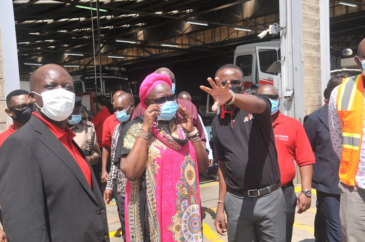 Toyota Kenya Chief Operations Officer Joshua Anya, Industrilization Cabinet Secretary Betty Maina and AVA Operations Manager Moses Obiero during the tour of the new Toyota assembly line at AVA MiritIini in Mombasa on Wednesday.