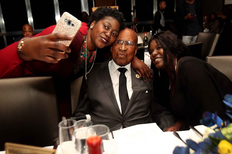 Dr Andrew Mlangeni flanked by his grand-daughter Mpumi Mlangeni, left and Sizakele Nkosi during his 93rd birthday celebration in Sandton.