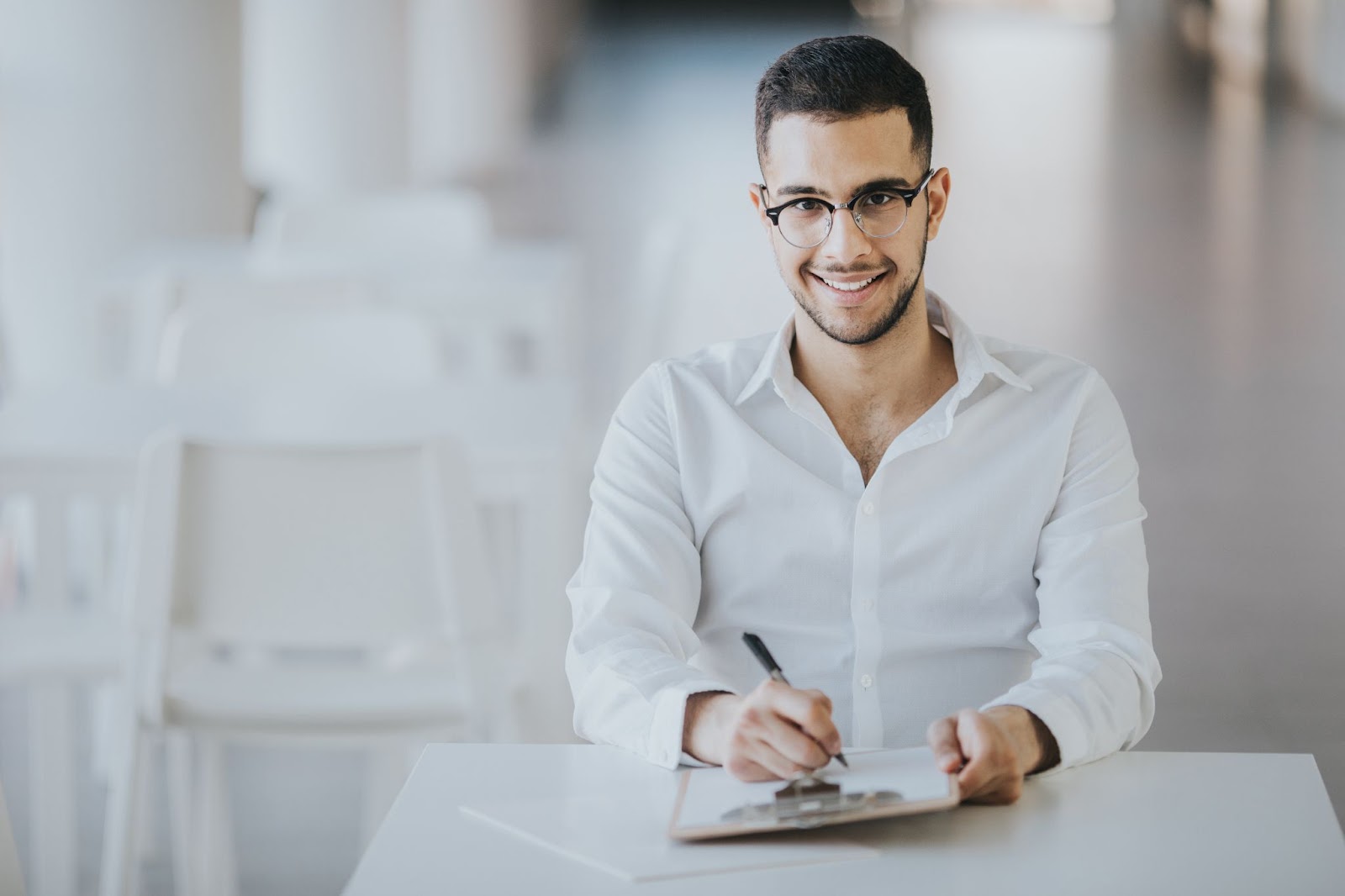 Man takes notes on clipboard