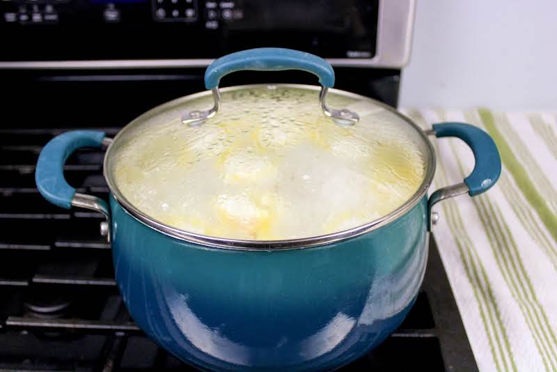 Covering The Saucepan While The Dumplings Cook.