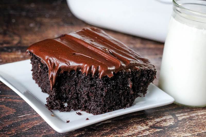 Slice Of Dragonfly Dark Chocolate Cake On A Plate.