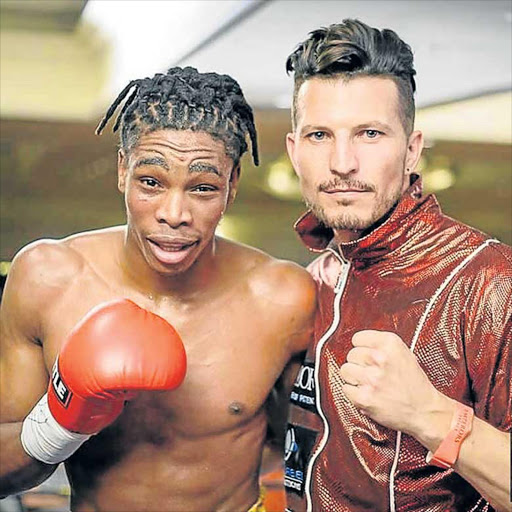 RED-HOT: Mdantsane-born Thulani Mbenge with trainer Sean Smith. Mbenge notched up his ninth straight win by stoppage this past weekend Picture: SUPPLIED