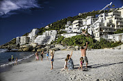 UP IN THE AIR: Tourists and locals enjoy Clifton Beach in Cape Town. Buyers and investors at the top end are now very hesitant to transact.