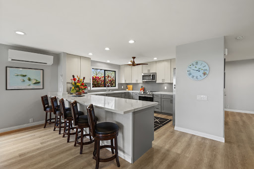 Modern kitchen with island and bar stools in this luxury property for sale in Lahaina ($1,499,000)