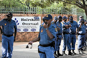 Police gather outside Ho�rskool Overvaal  where  protests erupted over failure to admit English-speaking pupils in an Afrikaans medium   school. / Alaister Russell