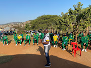 Lamontville Golden Arrows coach Steve Komphela addresses his team who went to pay respects to Nkanyiso Mngwengwe’s family. The former club skipper died during lockdown in May.  