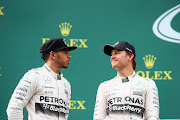 SPIELBERG, AUSTRIA - JUNE 21:  Nico Rosberg of Germany and Mercedes GP speaks with Lewis Hamilton of Great Britain and Mercedes GP on the podium after winning the Formula One Grand Prix of Austria at Red Bull Ring on June 21, 2015 in Spielberg, Austria.  (Photo by Mark Thompson/Getty Images)