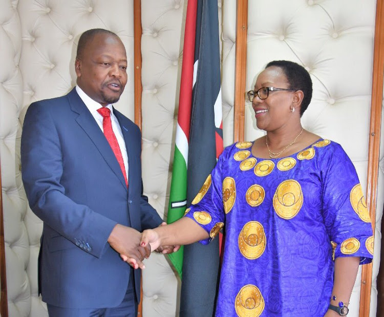 Health Cabinet Secretary Mutahi Kagwe and Sicily Kariuki, now the Cabinet Secretary for Water and Sanitation, during the handover on February 28.