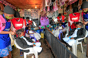 In Nairobi, Kenya this  week, Martha Apisa, left, and Stacy Ayuma get their hair plaited in the 'coronavirus'  style  as a fashion statement against the pandemic. 