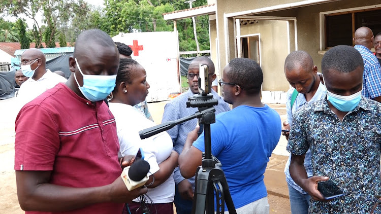 Journalists a outside the Malindi mortuary after the briefing of day two of the postmortem where pathologists announced they did postmortem of 30 bodies .