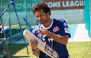 Sachin Tendulkar inspects his bat during the Mumbai Indians training session at Sahara Park Newlands on October 17, 2012 in Cape Town, South Africa.