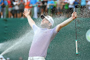 SOAKING IT UP  Branden Grace celebrates after winning the final round of the Nedbank Golf Challenge at the Gary Player Country Club at Sun City on Sunday