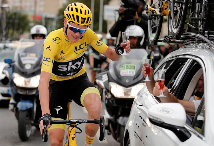 Chris Froome of Great Britain and Team Sky toasts a glass of champagne with his team during stage twenty one of Le Tour de France 2017 on July 23, 2017 in Paris, France.