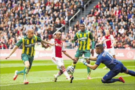 GIFTED: Thulani Serero of Ajax tries to get his shot in while fending off a tackle from Vito Wormgoor of ADO Den Haag as keeper Gino Coutinho closes in during the Dutch Eredivisie match at Amsterdam Arena on Sunday. Serero scored one goal and set up another in a 3-2 win Photo: VI Images via Getty Images