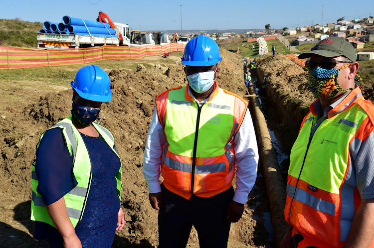 Acting mayor Thsonono Buyeye, centre, council speaker Buyelwa Mafaya and water and sanitation senior director Barry Martin visit the site on Monday where work is being done at Joe Slovo West to repair the main water pipeline to the west side of the city.