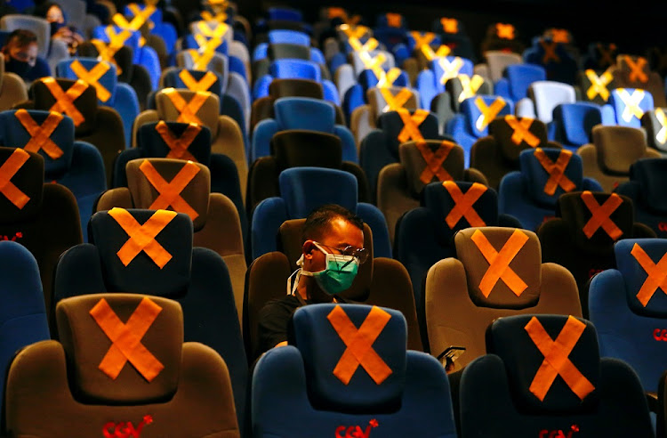 People sit far apart at the CGV cinema amid the COVID-19 pandemic in Jakarta, Indonesia, October 21 2020.