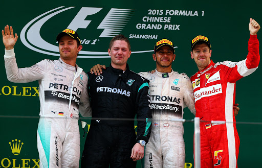 SHANGHAI, CHINA - APRIL 12: Second placed Nico Rosberg (L) of Germany and Mercedes GP, first placed Lewis Hamilton (2nd R) of Great Britain and Mercedes GP and Sebastian Vettel (R) of Germany and Ferrari wave to the fans following the Formula One Grand Prix of China at Shanghai International Circuit on April 12, 2015 in Shanghai, China. (Photo by Dan Istitene/Getty Images)