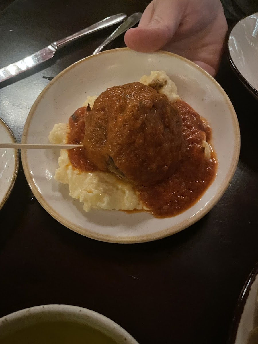 Polette (giant meatball) served over polenta.