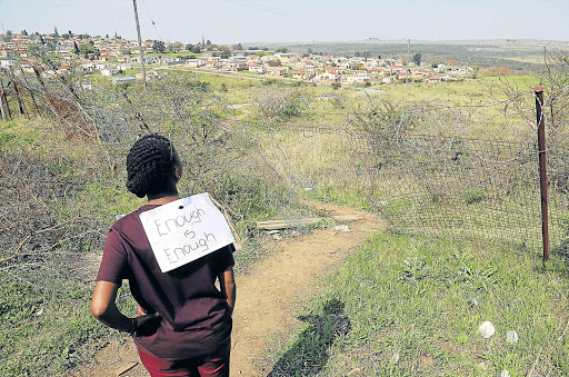 DANGER: SRC president Sindiswa Gcobo shows the broken fencing around the Lovedale Zwelitsha campus after a student was raped last week Picture: ALAN EASON