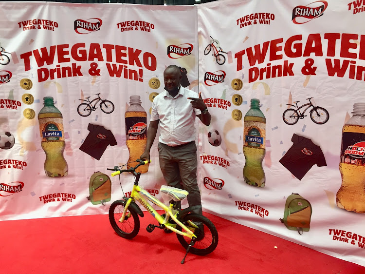 One of the winners of the bicycles during the launch pausing with his prize