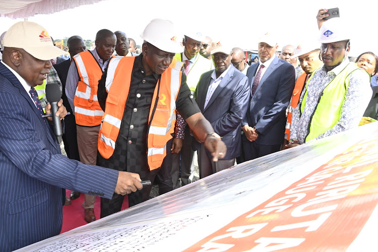 President William Ruto being show the upcoming project during the launch of the construction works for the Riruta-Ngong Commuter Rail line, Ngong, Kajiado County on December 15, 2023