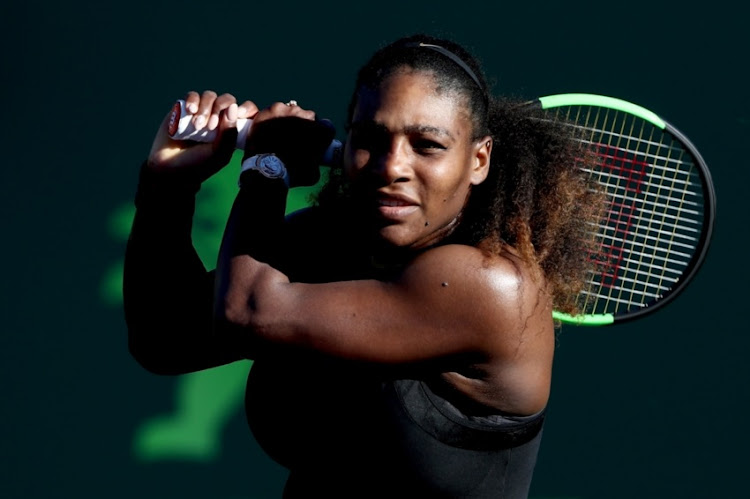 Serena Williams returns a shot to Naomi Osaka of Japan during the Miami Open Presented by Itau at Crandon Park Tennis Center on March 21, 2018 in Key Biscayne, Florida.