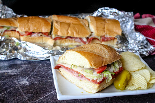 Hot Hero Sandwich on a plate with chips.