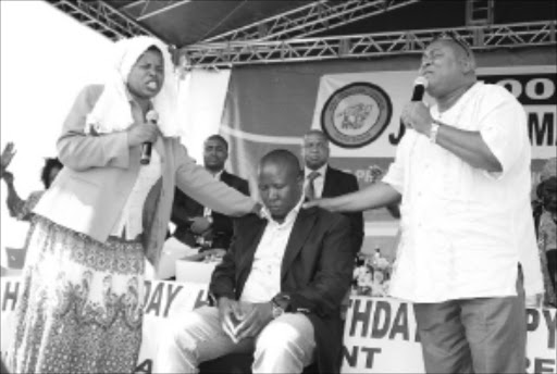 03 MARCH 2010 WEDNESDAY: Julius Malema, ANCYL president prays by pastors Jacqueline Selolo and Clement Koma for preventing him to attack by journalists during his birthday party held at Seshego Stadium on Wednesday. PIC: ELIJAR MUSHIANA. 03/03/2010. © SOWETAN