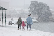 Residents come out to see and play in the snow, 10 July 2023, at Jackson Dam in Alberton, South of Johannesburg. 