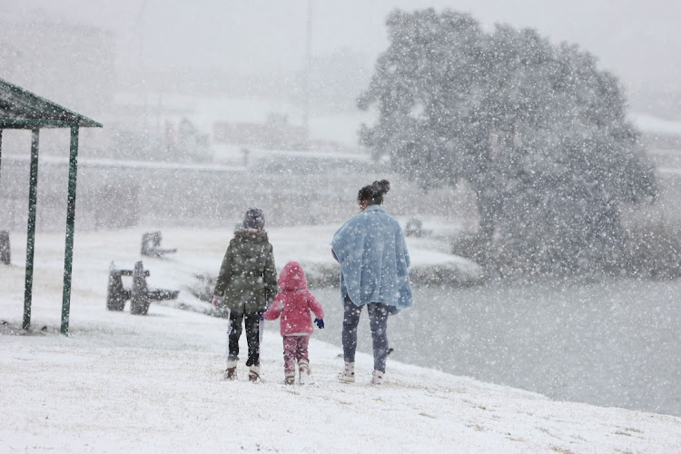 Residents come out to see and play in the snow, 10 July 2023, at Jackson Dam in Alberton, South of Johannesburg.