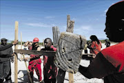 STAKING A CLAIM:  EFF members nail planks together during an attempted land invasion in Khayelitsha, Cape Town Photo: SHELLEY CHRISTIANS