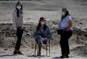 Tourists visit the Colossi of Memnon (not pictured), the ruins of two stone statues that guarded the mortuary temple built for Pharaoh Amenhotep III, amid the coronavirus disease pandemic in the West Bank of Luxor, Egypt, on April 10 2021. 