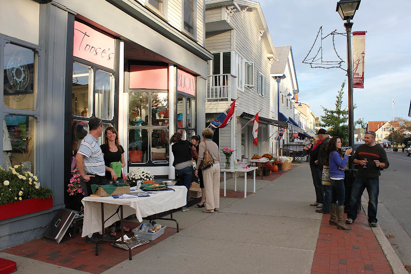 Shopkeepers in front of their stores on the main street in St. Andrews by-the-Sea, Canada. 