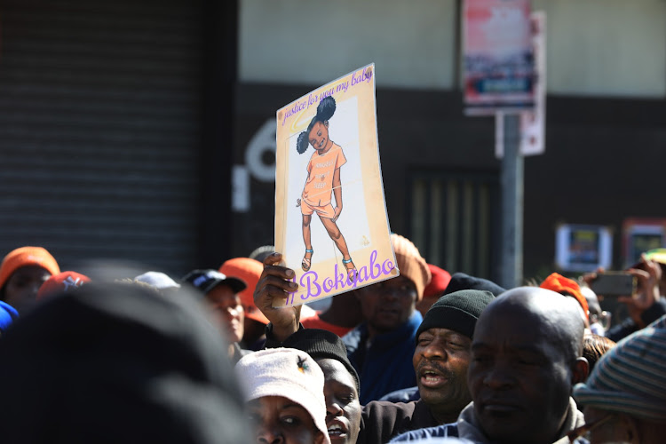 The community has rallied around Bokgabo Poo's family as they seek justice after her murder. Marchers wore orange, the little girl's favourite colour.