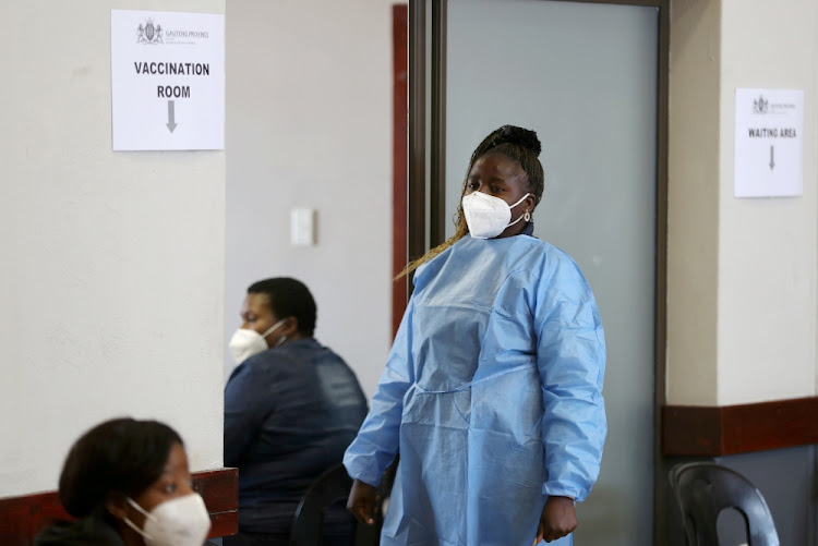 A health worker looks on as she waits to give a dose of a coronavirus disease (COVID-19) vaccine during a vaccine rollout for teachers in Meyerton, south of Johannesburg, South Africa June 23, 2021.