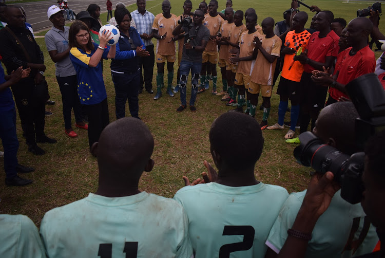 European Union Ambassador to Kenya Henriette Geiger and Homa Bay Governor Gladys Wanga speak to Ringa Boys team at Raila Odinga stadium in Homa Bay town on April 7,2024