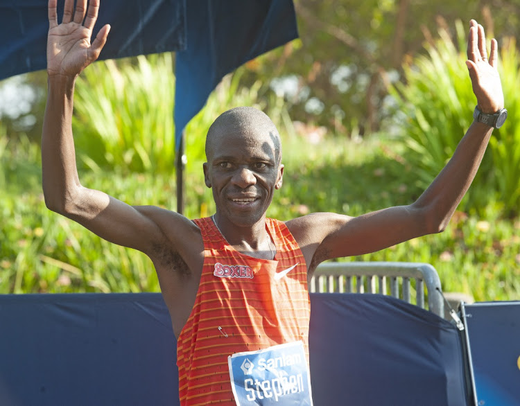 Stephen Mokoka of South Africa wins the Men 42.2km Elite race during the 2022 Sanlam Cape Town Marathon at Green Point Athletics Stadium on October 16, 2022 in Cape Town, South Africa.