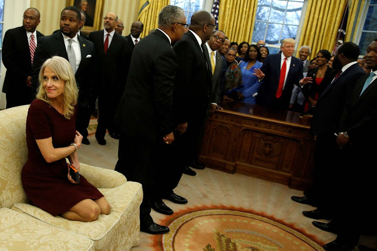 Senior advisor Kellyanne Conway (L) attends as US President Donald Trump (behind desk) welcomes the leaders of dozens of historically black colleges and universities (HBCU) in the Oval Office at the White House in Washington.