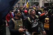 Proud Boys members Enrique Tarrio, left, and Joe Biggs march during a December 12, 2020 protest in Washington, D.C. 