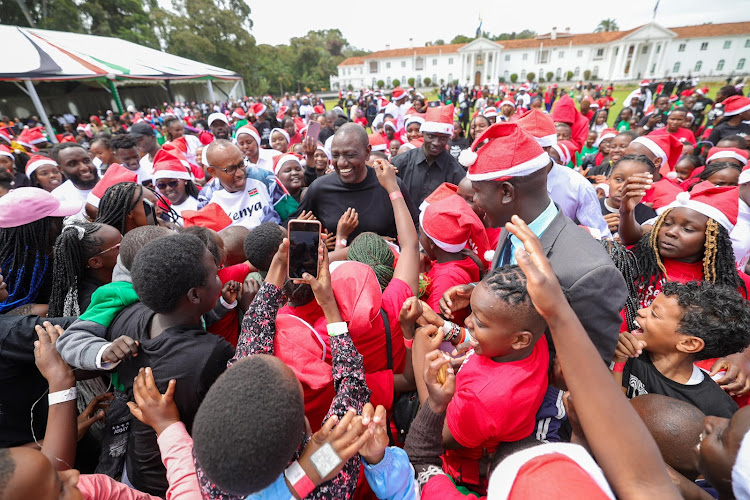 President William Ruto interacts with children during a Christmas party at State House Nairobi on December 19, 2023.