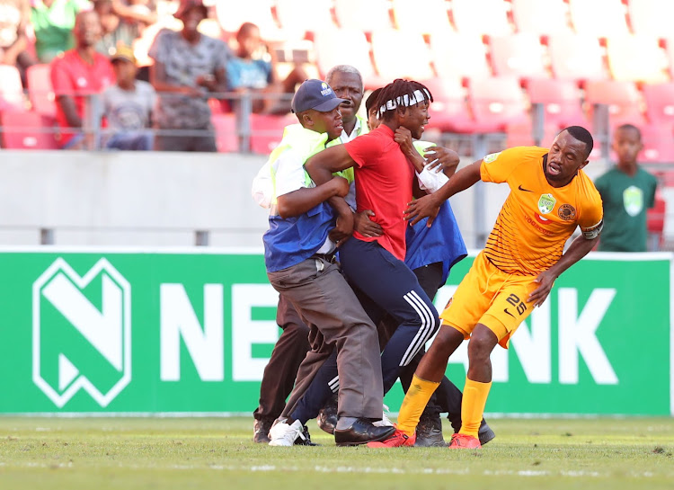 Kaizer Chiefs forward Bernard Parker under what looks like an attack from a fan who invaded the pitch during a Nedbank Cup last 16 encounter against amateur side The Magic Fc at the Nelson Mandela Bay Stadium in Port Elizabeth on February 17 2019.