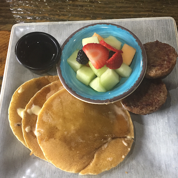 Gluten free pancakes with pork sausage and fruit