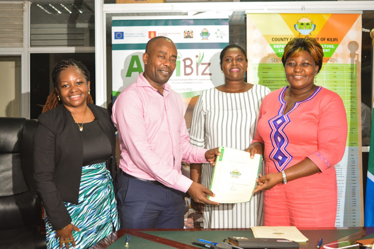 Kenya Climate Innovation Centre CEO Edward Mungai exchanges the signed MOU with Kilifi county officials