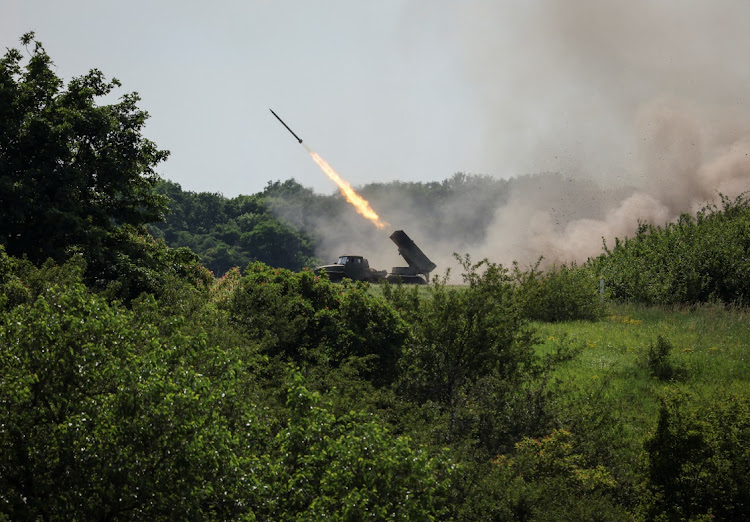 Ukrainian service members fire a BM-21 Grad multiple rocket launch system, near the town of Lysychansk, Luhansk region, amid Russia's attack on Ukraine June 12, 2022.