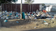 Piles of rubbish uncollected for three weeks line the streets at Cambridge informal settlement in East London. 