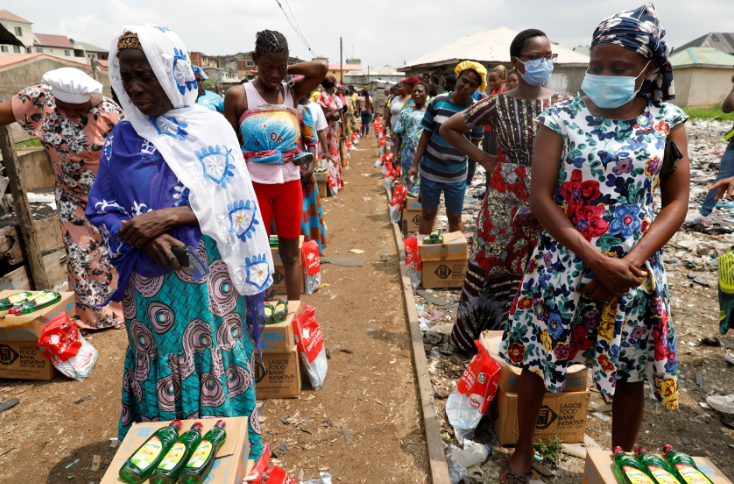 Women queue for food parcels during distribution by volunteers of the Lagos food bank initiative in a community in Oworoshoki, Lagos, Nigeria on July 10, 2021.