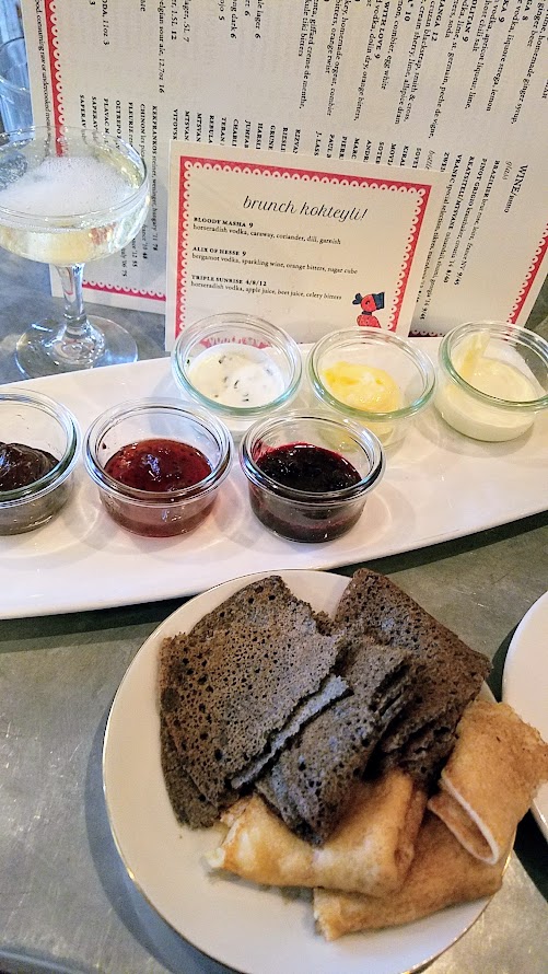 Kachka Maslenitsa brunch second course of a platter of sweet and savory accompaniments for the regular and buckwheat blinis included chocolate butter, gooseberry jam, lingonberry jam, farmers cheese with green onion, cultured butter, and housemade sour cream