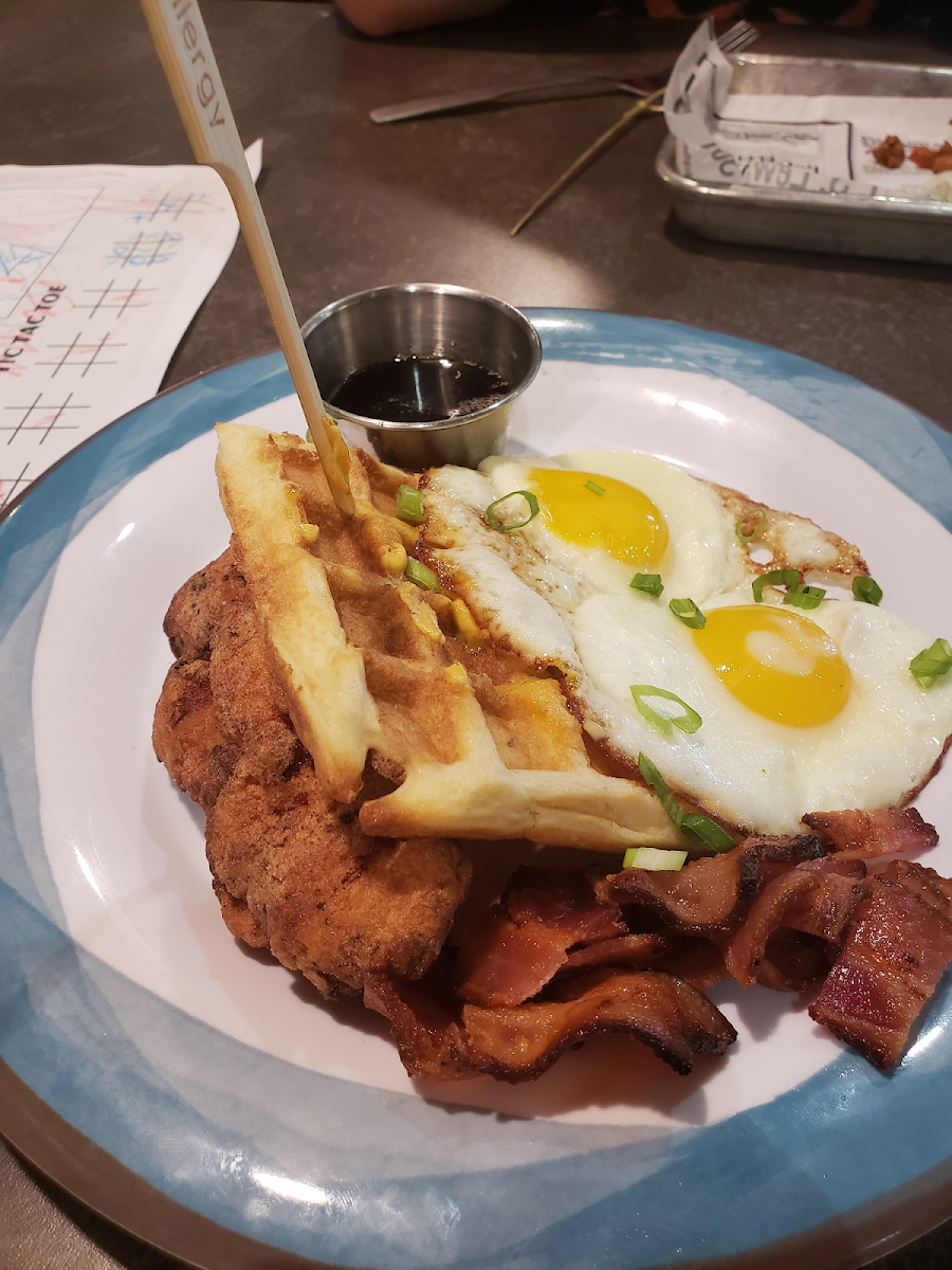 Chicken and waffle with eggs and bacon