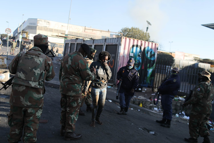 Members of the South African Defence Force patrol in Alexandra, Johannesburg.