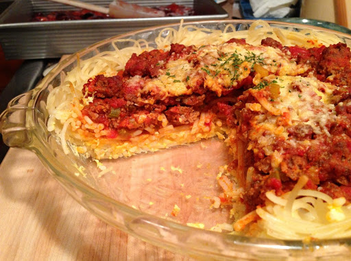 Spaghetti Pie. A tasty, unique presentation for family supper, or a casual dinner with friends.  It is a neat solution to digging into your favorite spaghetti dinner, only neater! No spoons for twirling, or bibs for splashing required, great for the kids.